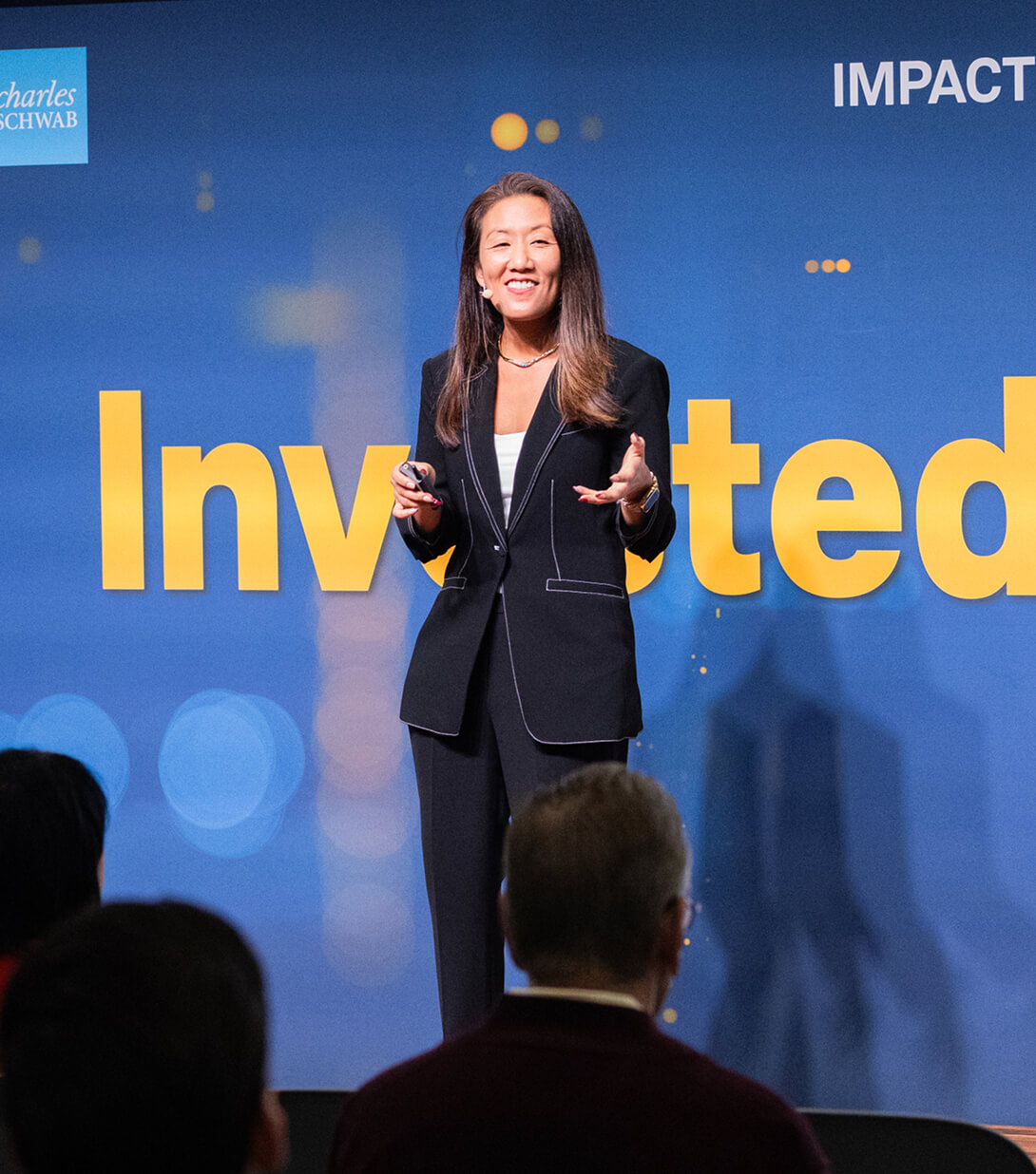 Woman speaking onstage at IMPACT 2024.