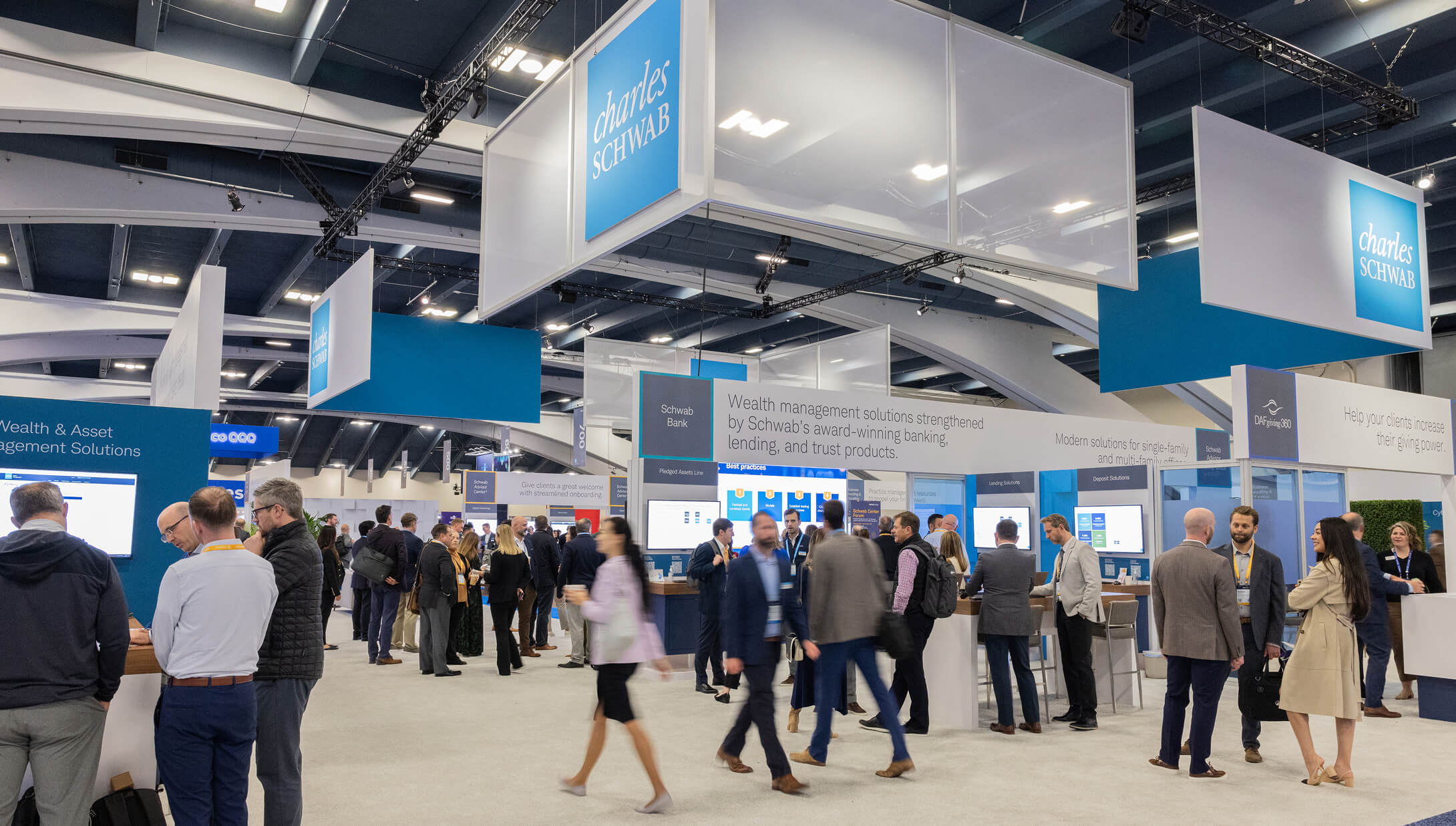 People mingling in Schwab Center at IMPACT 2024.