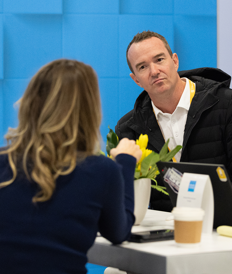 People in seated conversation.