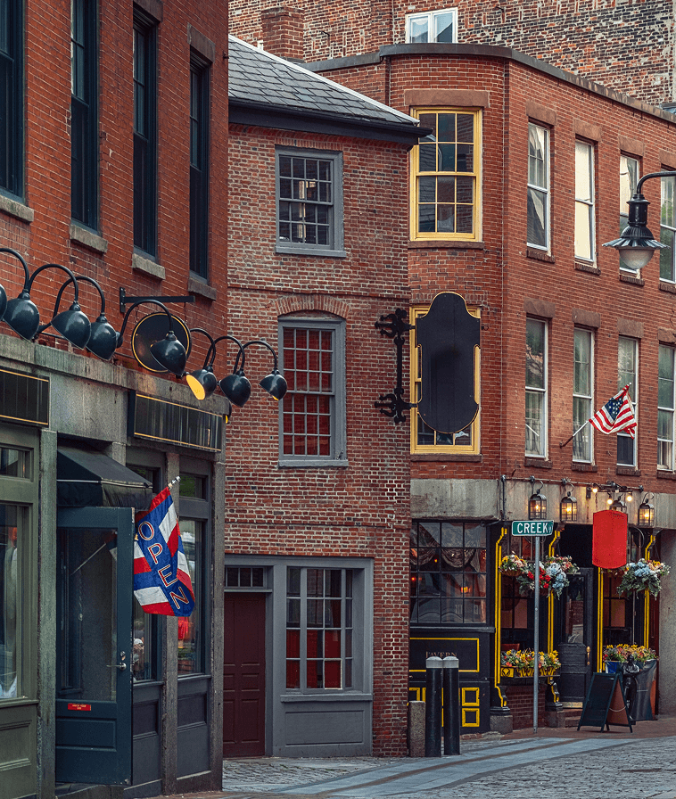 Brick buildings along a cobblestone street in historic Boston.