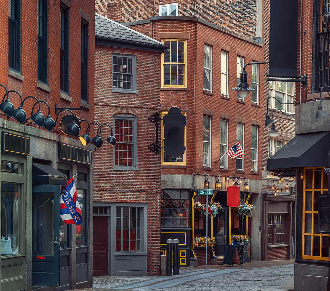 Brick buildings along a cobblestone street in historic Boston.