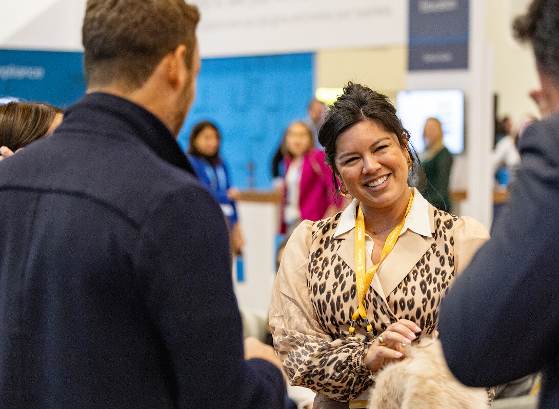 People interacting in The Exchange at IMPACT 2024.