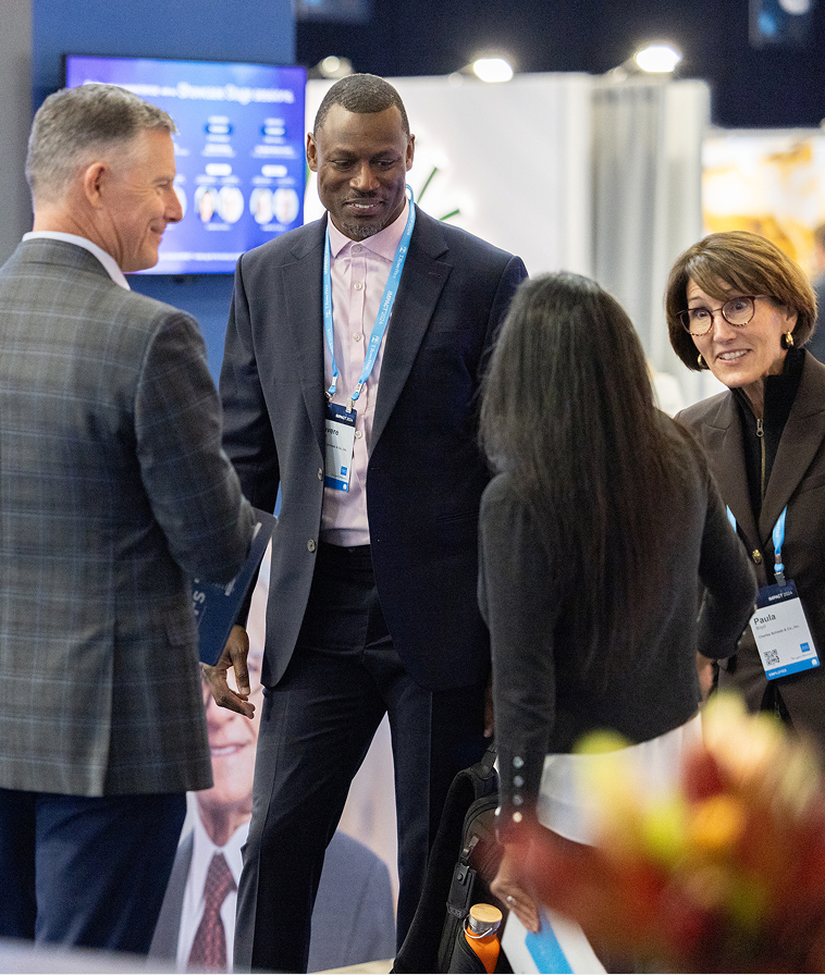 People interacting in The Exchange at IMPACT 2024.