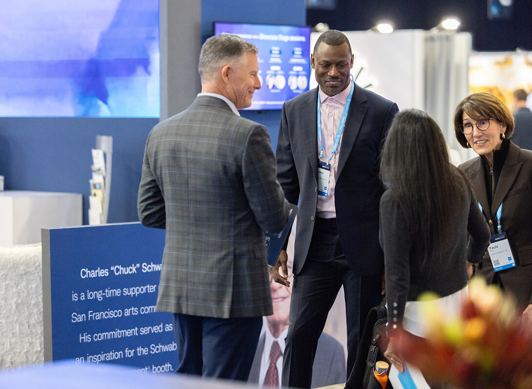 People interacting in The Exchange at IMPACT 2024.