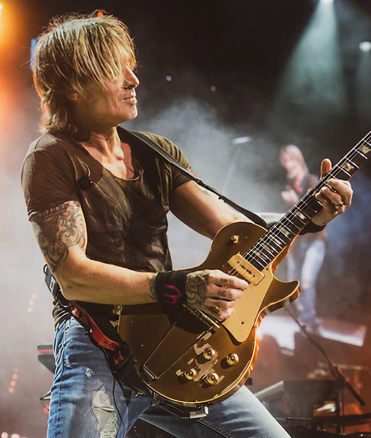 Keith Urban, Four-time Grammy Award winner and two-time CMA Entertainer of the Year, performing on stage.