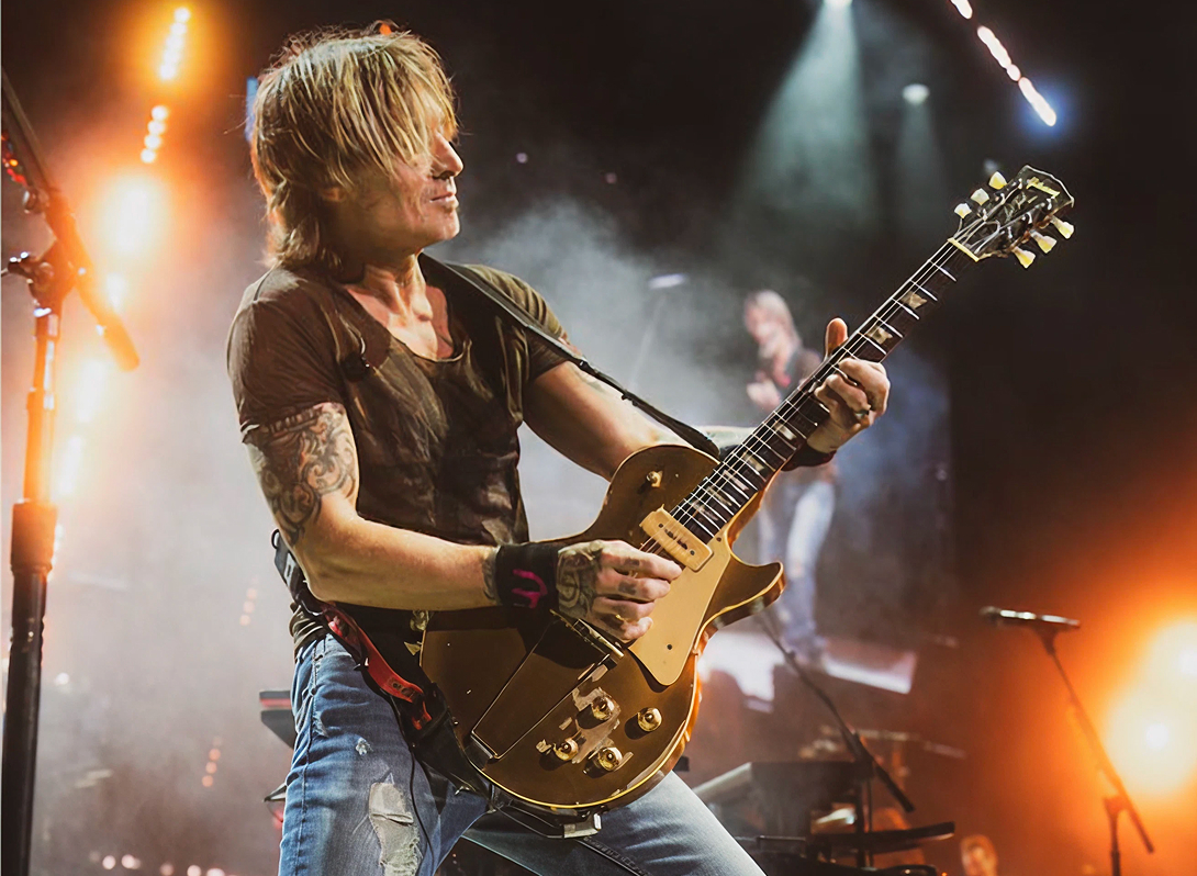 Keith Urban, Four-time Grammy Award winner and two-time CMA Entertainer of the Year, performing on stage.
