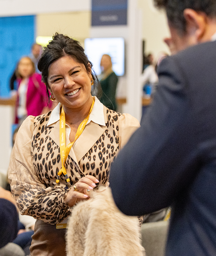 People interacting in The Exchange at IMPACT 2024.