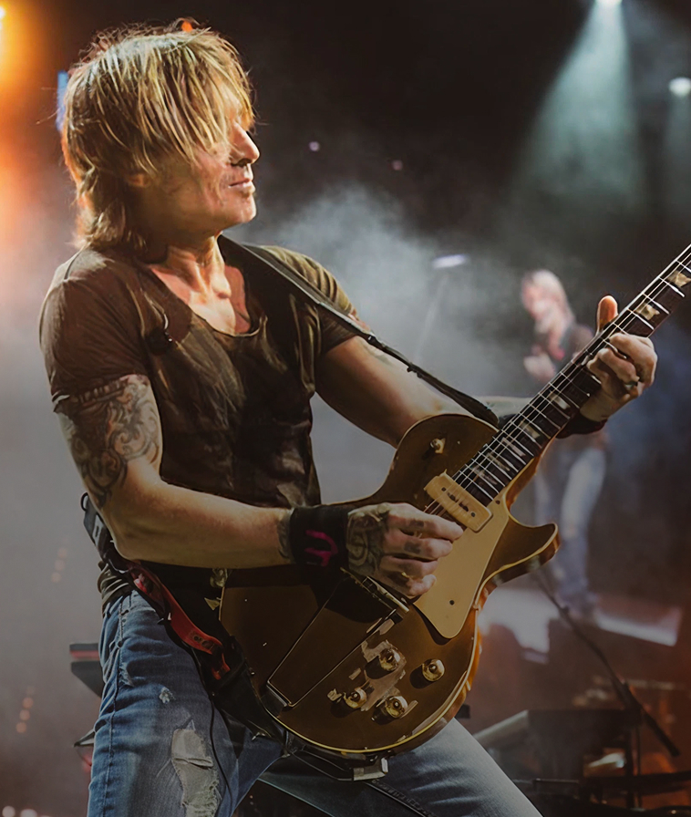 Keith Urban, Four-time Grammy Award winner and two-time CMA Entertainer of the Year, performing on stage.